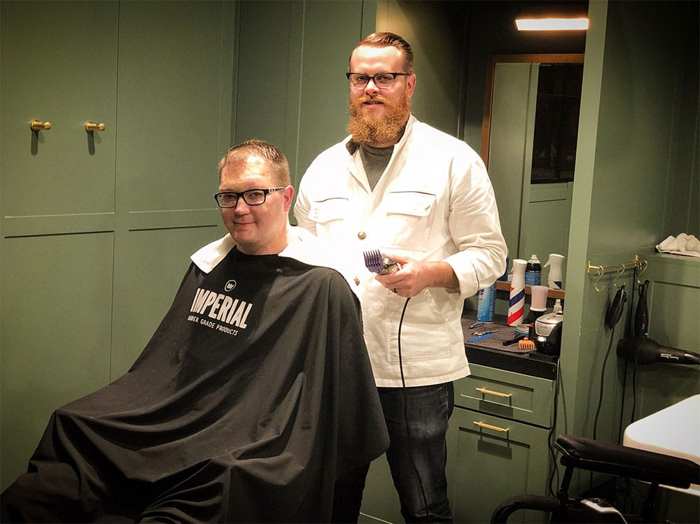 Getting a hair cut at The Adolphus Barber Shop.