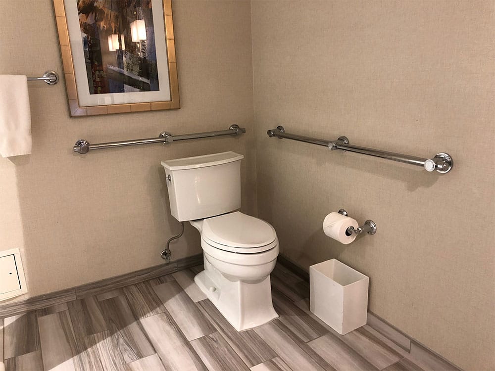 Accessible toilet with grab bars.