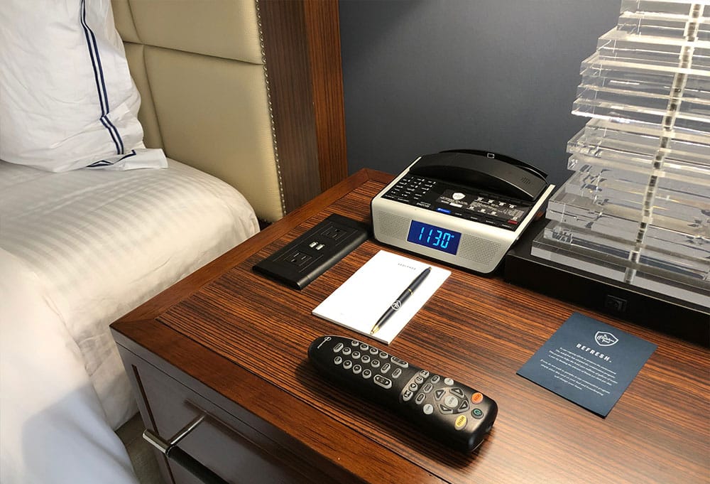 Power outlets located on bedside table.