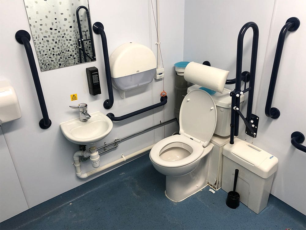 Accessible toilet with grab bars.