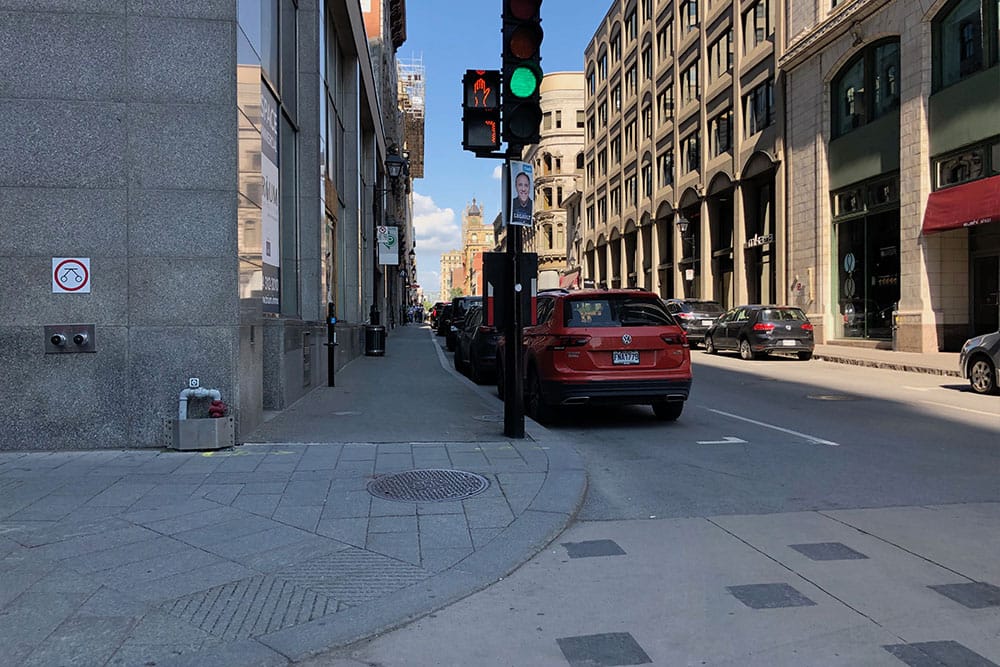 Wheelchair accessible sidewalk with curb cut ramp in Montreal.