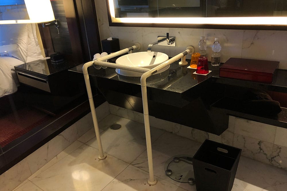 Bathroom sink with grab bars.