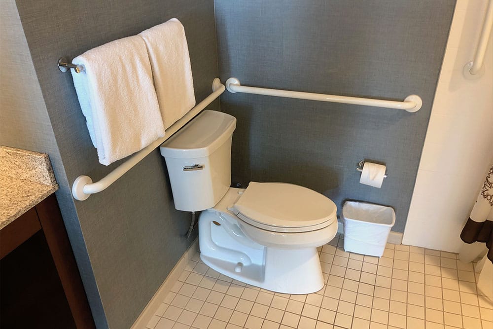 Wheelchair accessible toilet with grab bars.