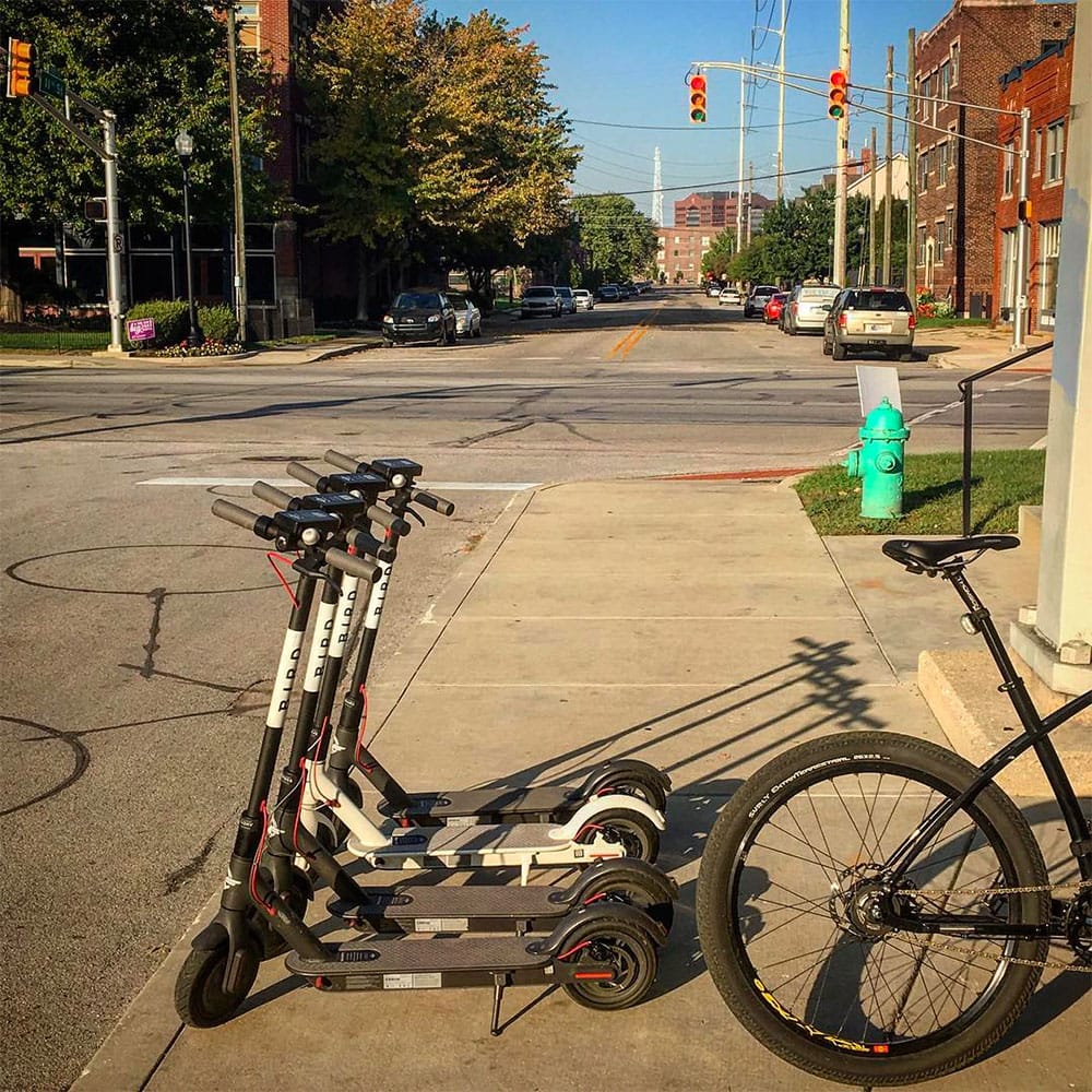 Bird scooters block a sidewalk in Indianapolis.