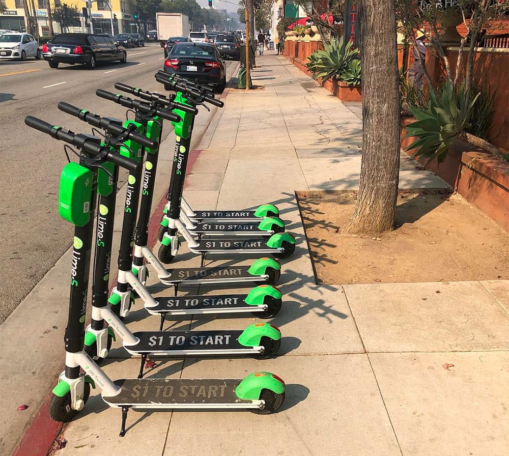 Lime scooters blocking a sidewalk in Santa Monica, CA.