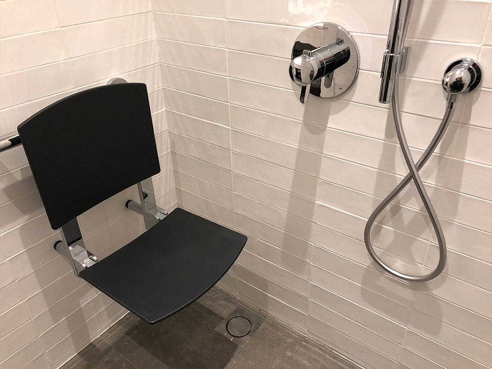 Wall-mounted shower chair.