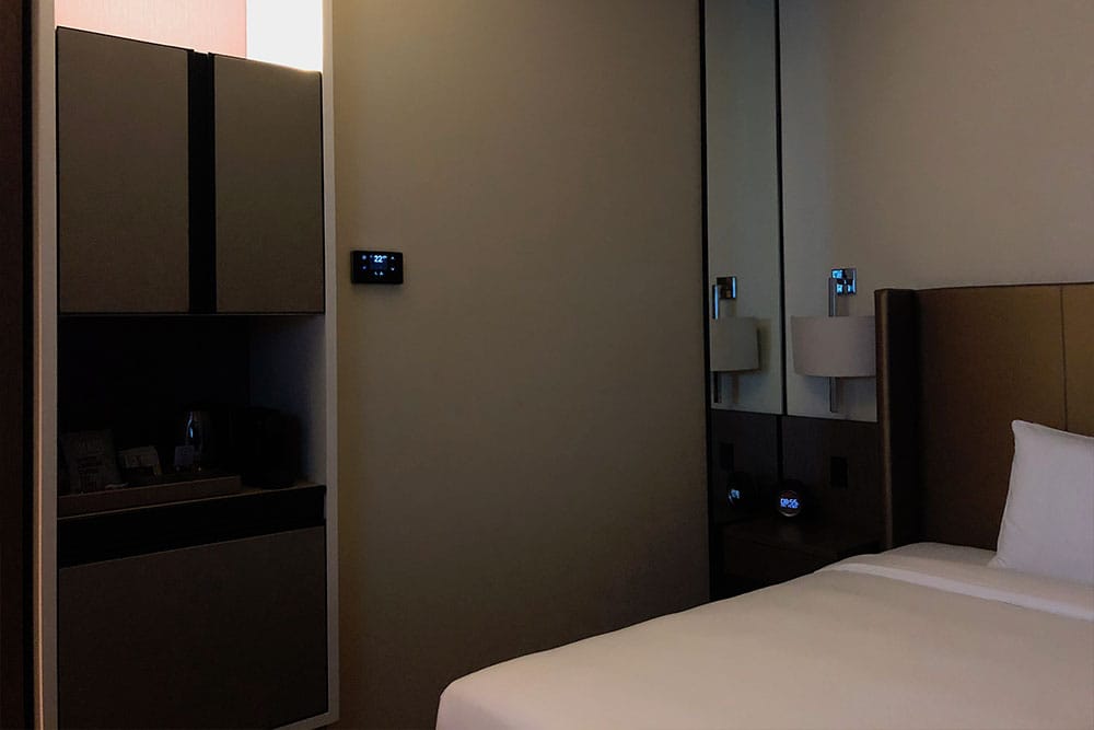 Thermostat and minibar are difficult to reach and located to the left of the bed.