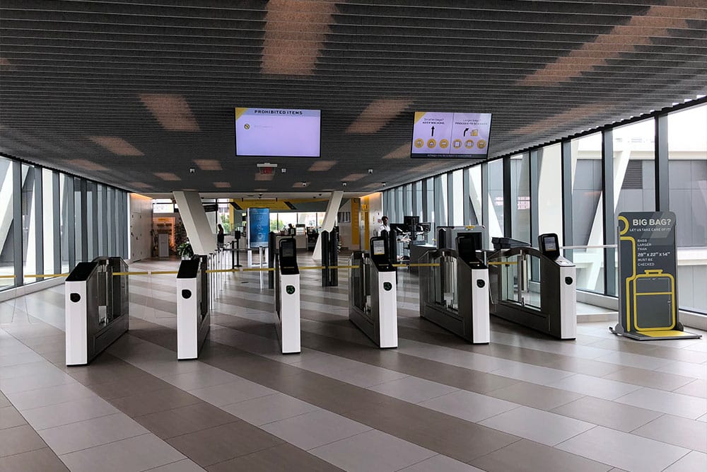 Ticket gates and security check at Brightline station.