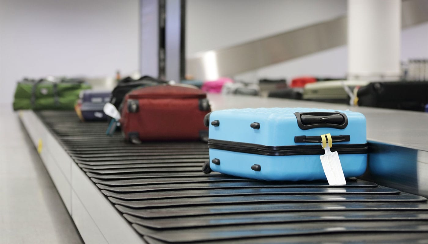 Pieces of luggage on the airport baggage carousel.