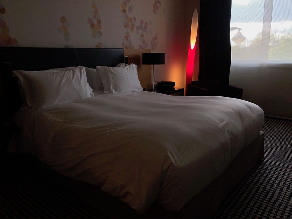 Queen size bed at Sofitel Hotel.