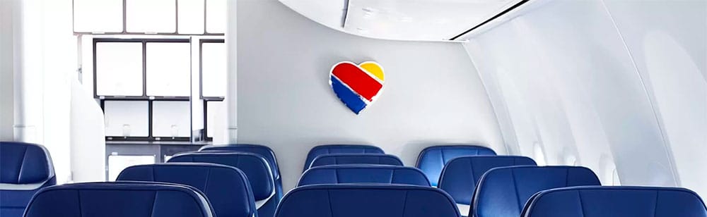 Iconic Southwest heart emblem on aircraft's bulkhead wall.