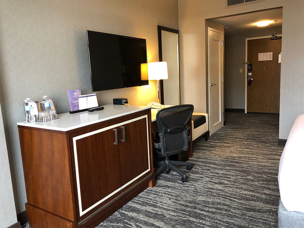 Television, desk and full-length mirror.