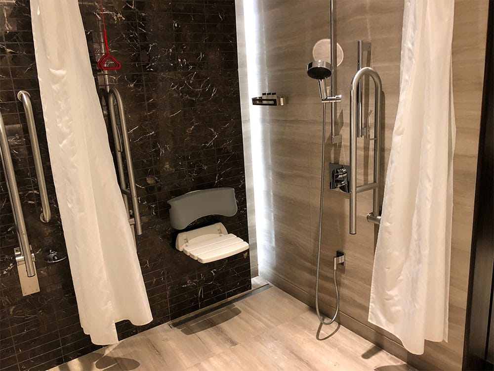 Roll-in shower with accessible features at Sheraton Grand Hotel, Dubai.