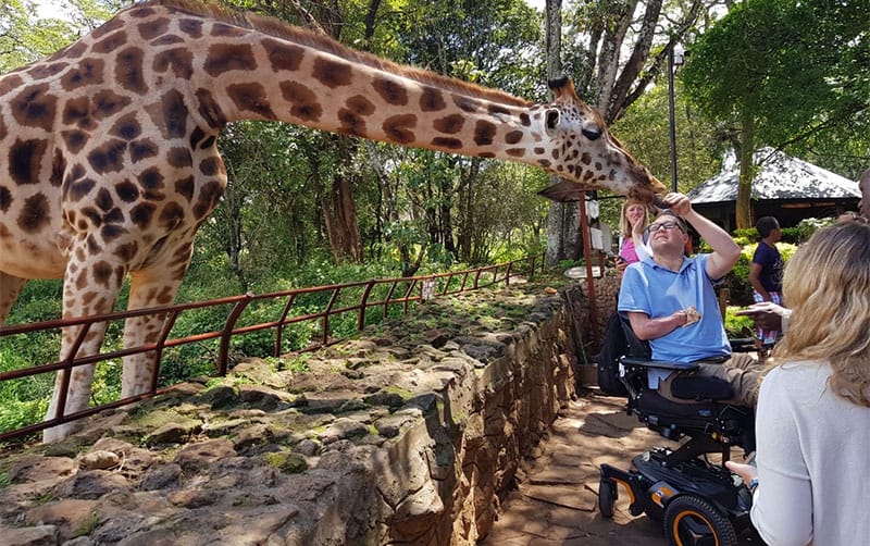 Wheelchair user John Morris at Kenya Giraffe Centre.