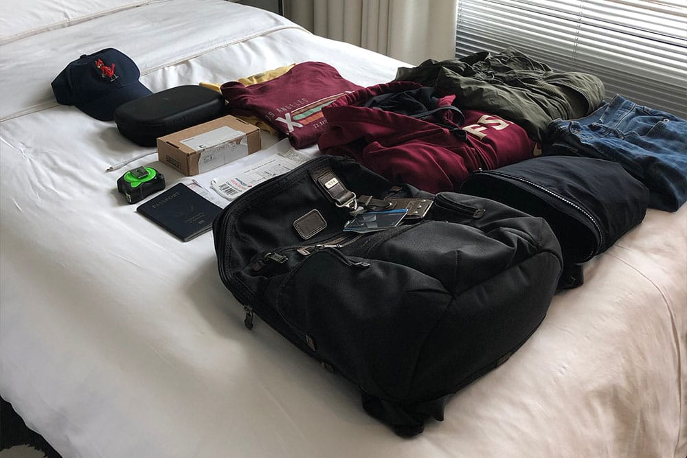 Folded clothes neatly arranged on bed.