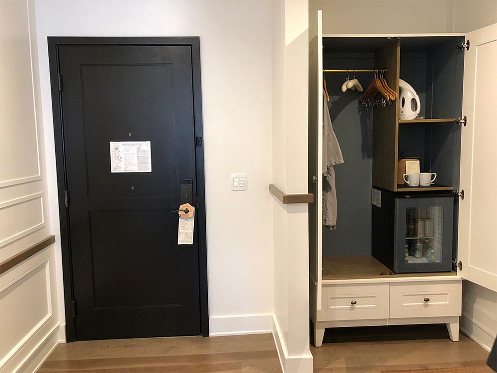 Hotel room door and a wardrobe closet.