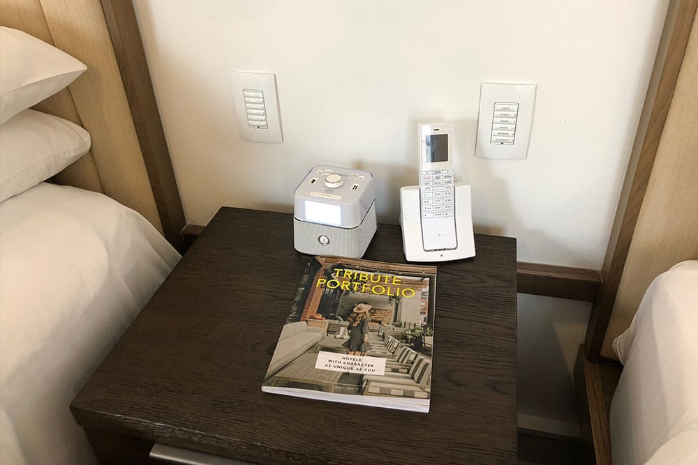 Nightstand between beds, with controls for lights & curtains.