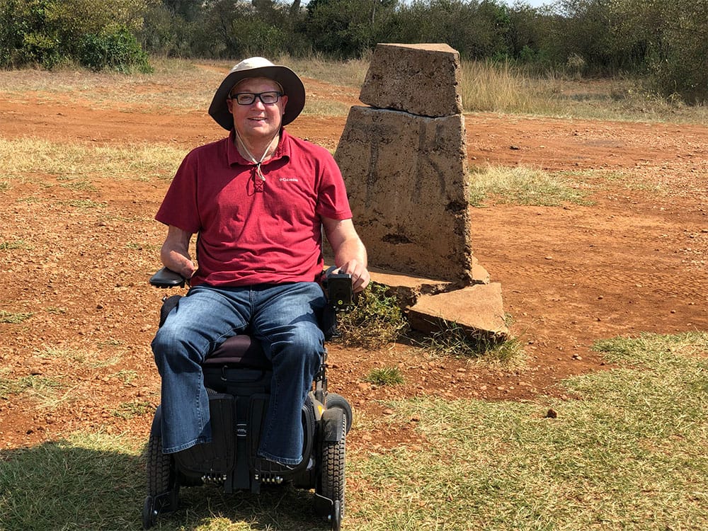 Rolling across the Kenya - Tanzania border in a wheelchair.