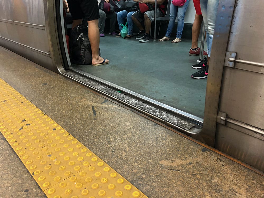 Metro train with doors open, stopped at station.