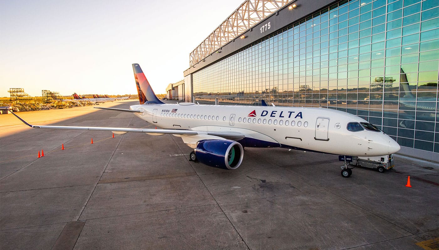 Delta Air Lines Airbus A220 parked at hangar.