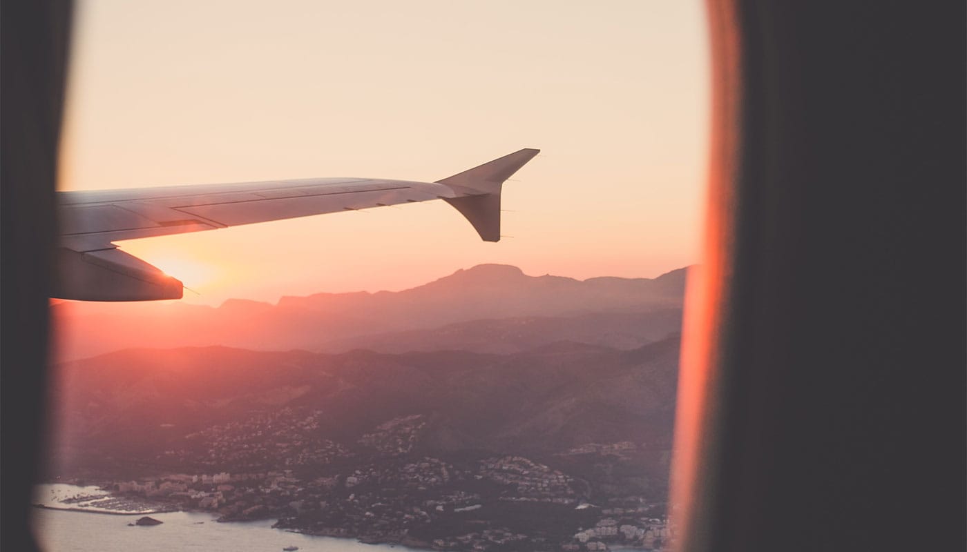 Airplane wing seen through window.