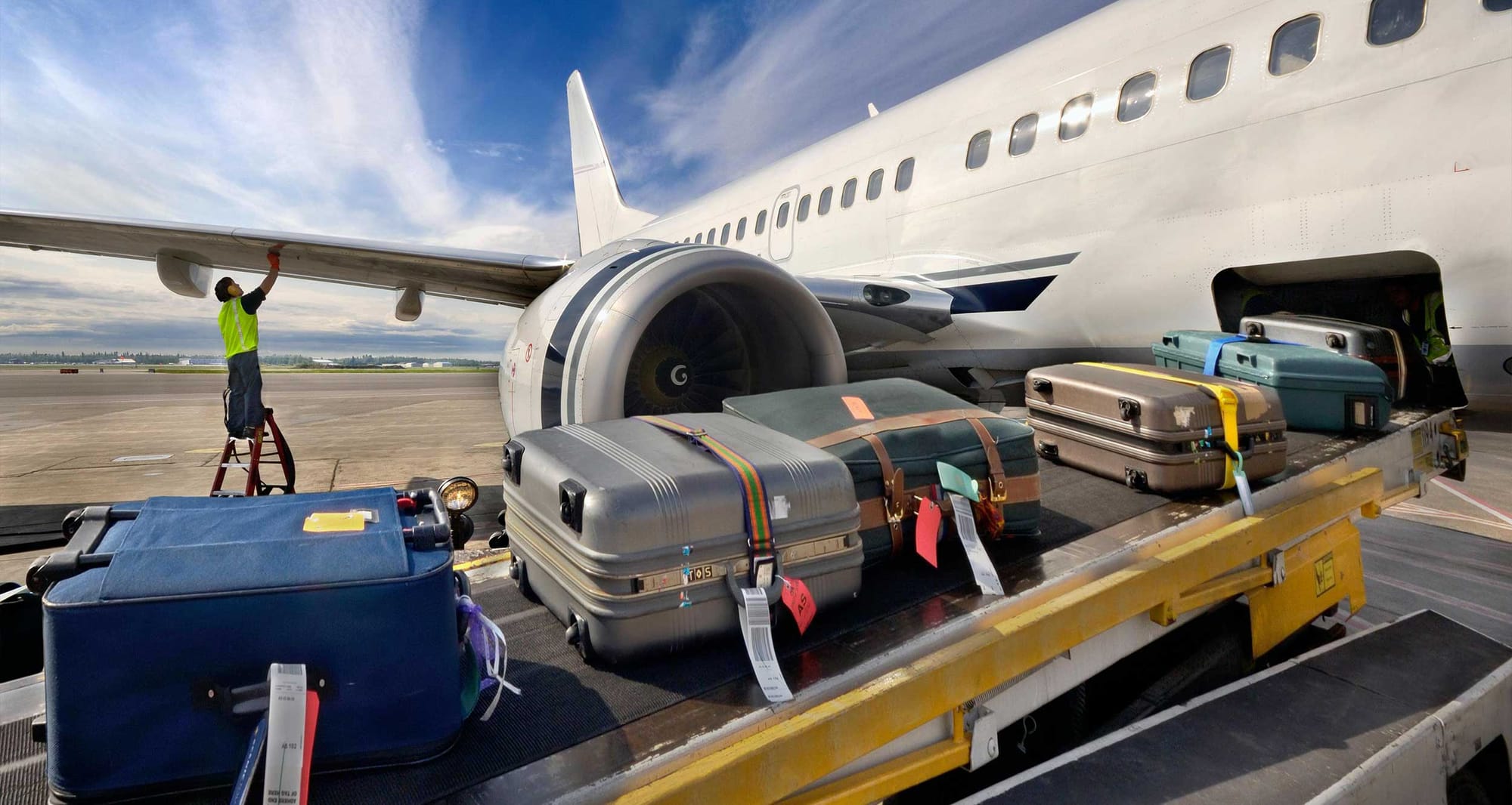 Baggage loaded into airplane cargo hold.