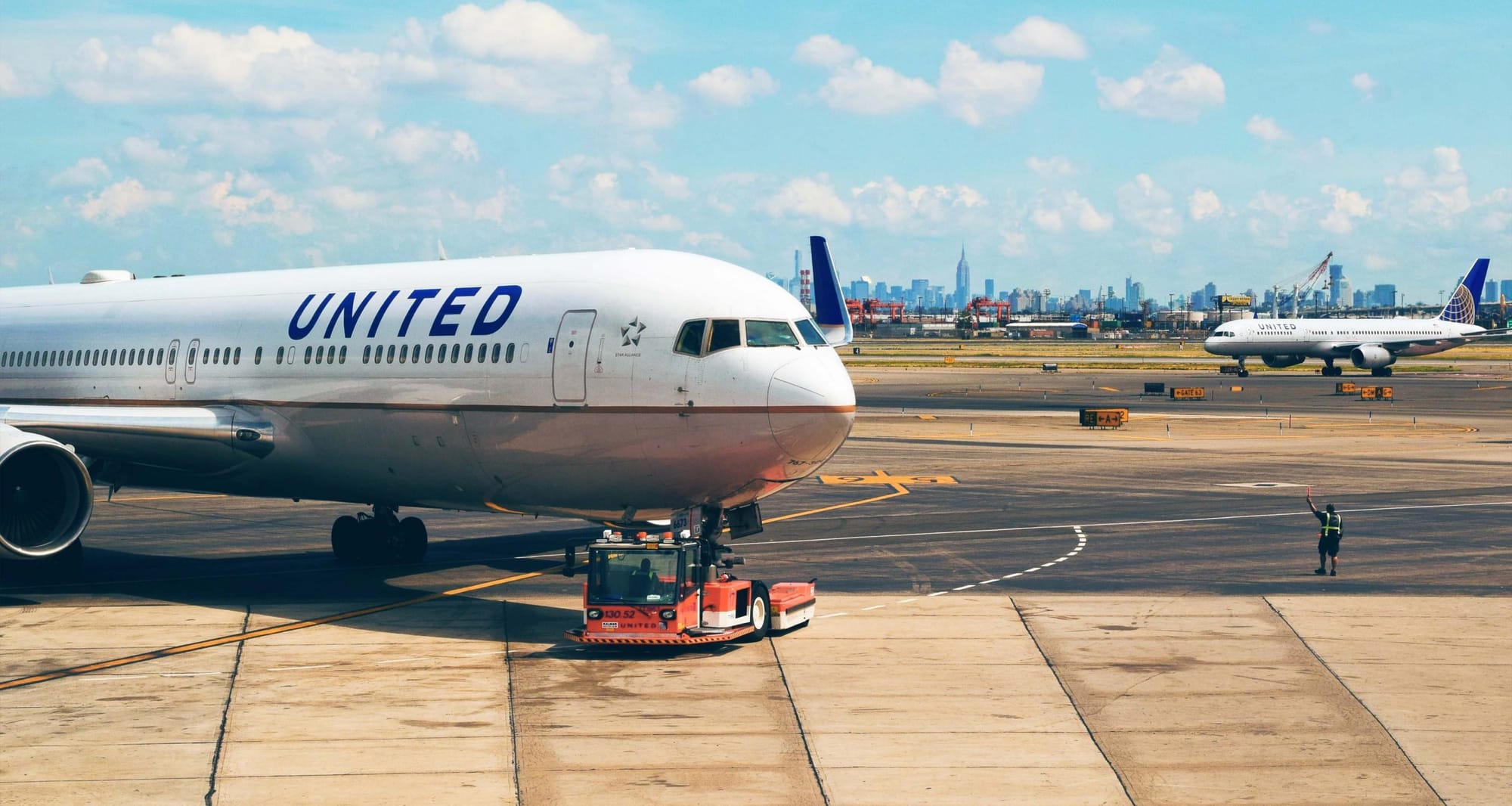 United Airlines airplane pushing back from gate.