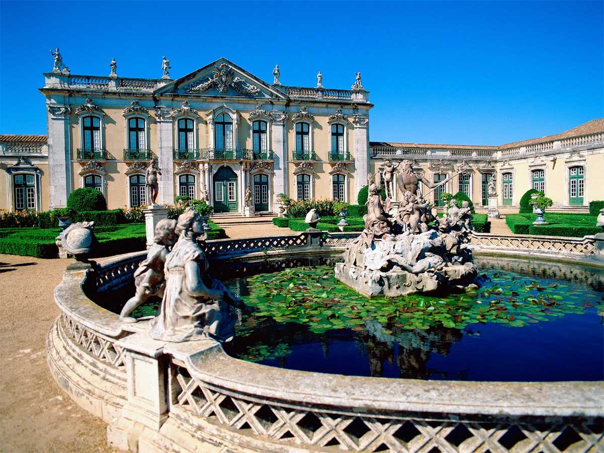 Palace with large fountain in front.