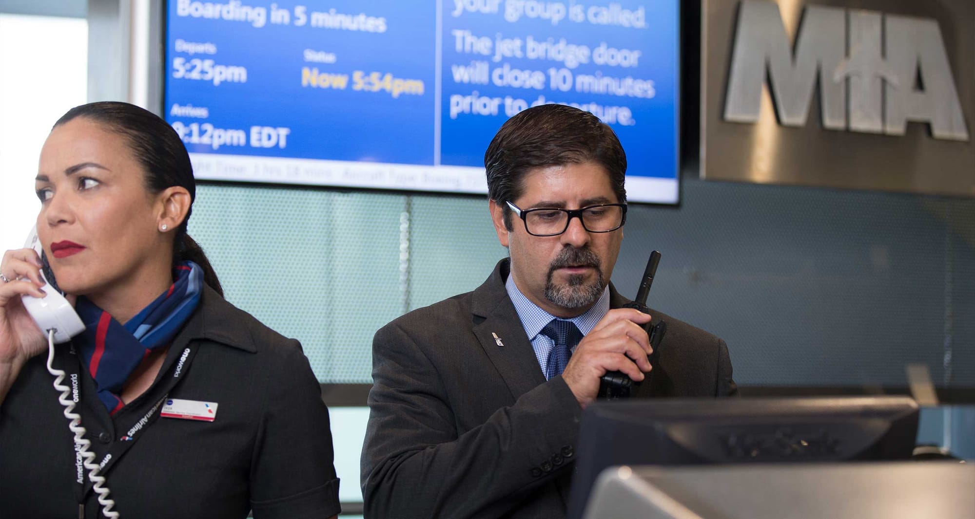 American Airlines agents at gate terminal.