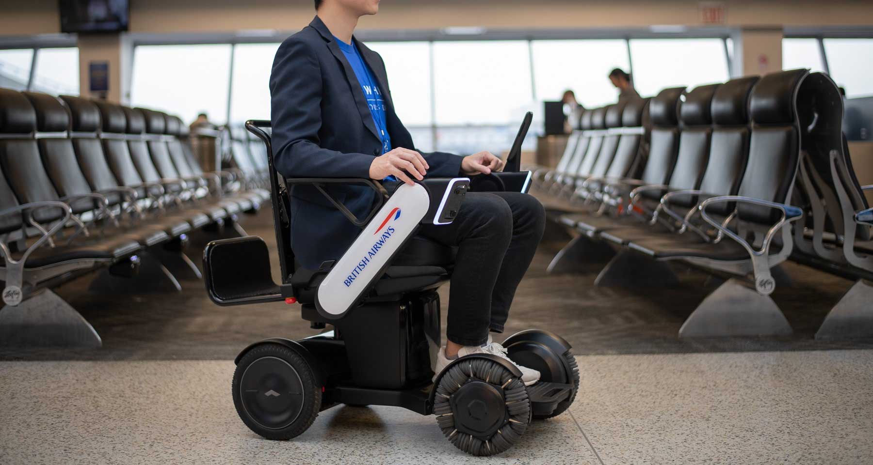 Man riding on autonomous BA branded wheelchair.