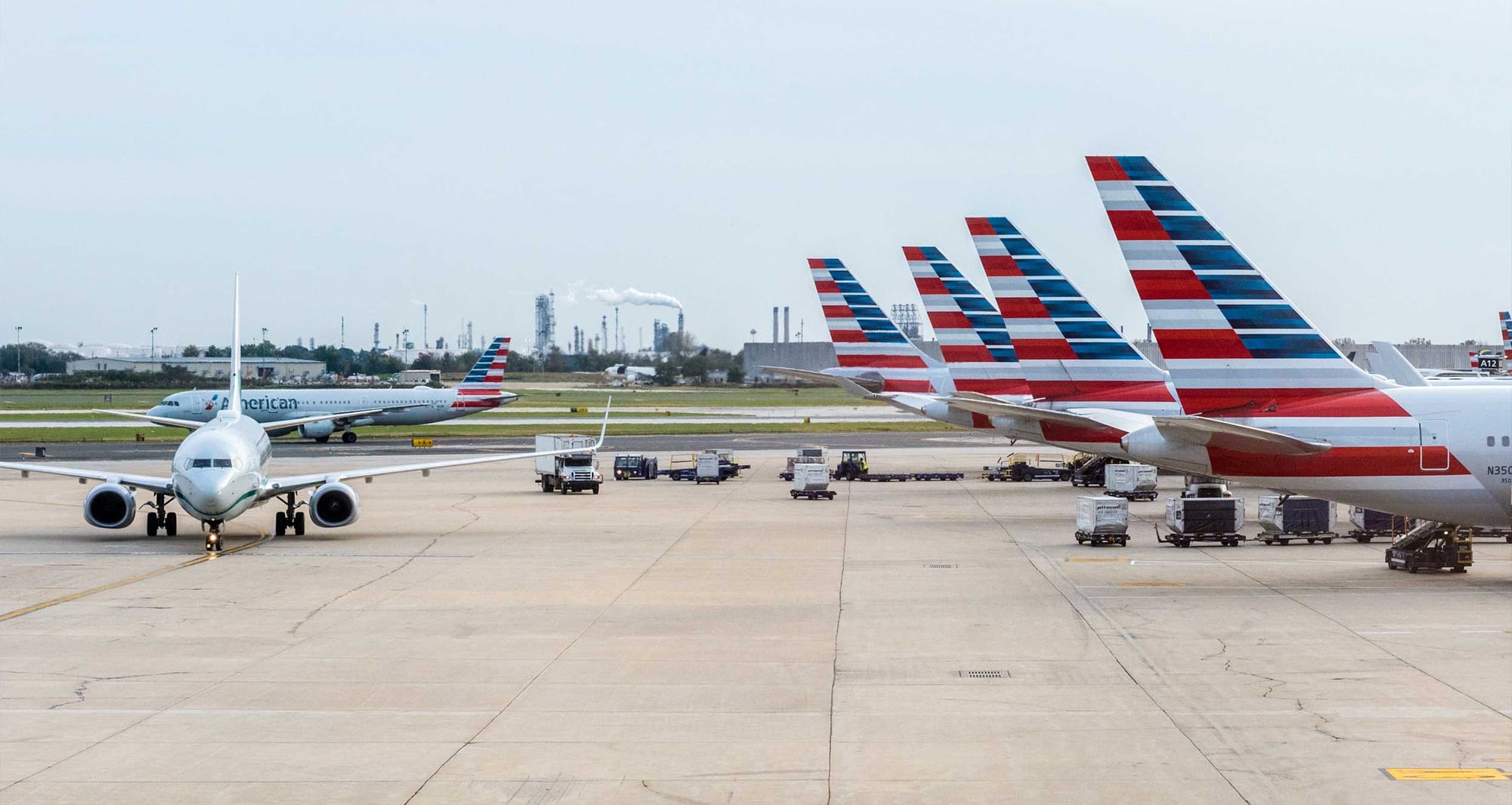 American Airlines planes parked at airport terminal.