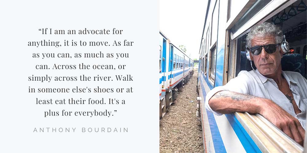 Anthony Bourdain looking through the window of a train.