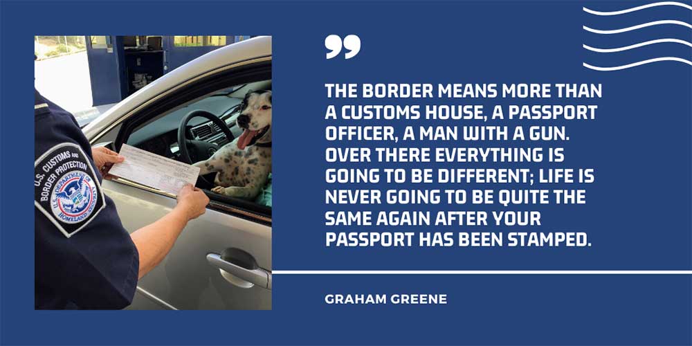 Border patrol officer checking the documents of a woman who is seated in a car with her dog.