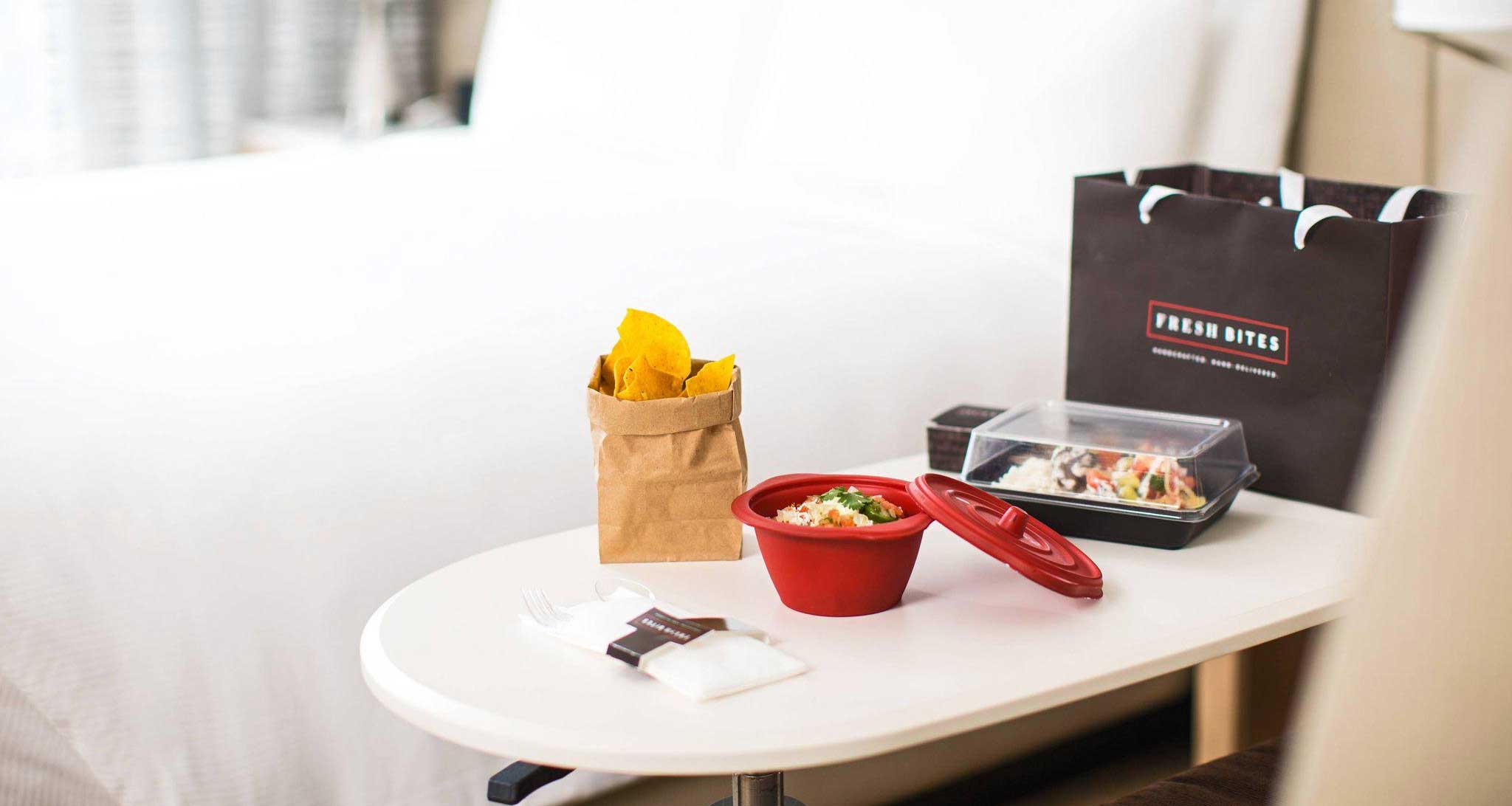 Fresh bites meal food and packaging displayed in a hotel room.