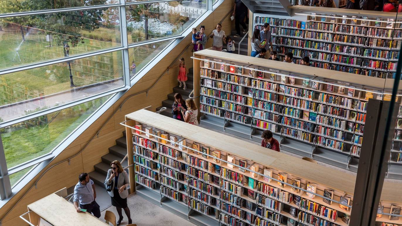 Tiered levels of bookshelves, each accessible by a staircase to the left.