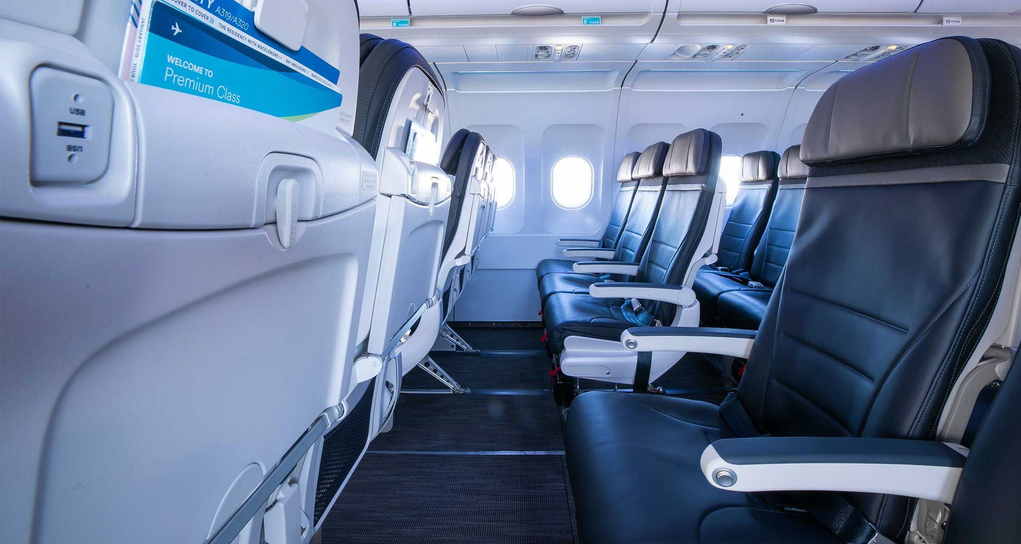 Row of economy class seats on Alaska Airlines airplane.