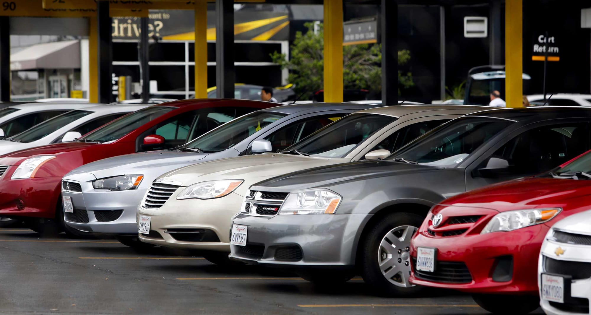 Line of cars at a Hertz rental center.