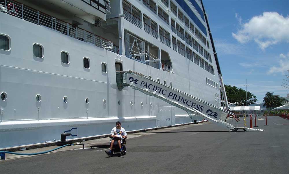 Gordon, sitting in his wheelchair next to the Pacific Princess cruise ship.