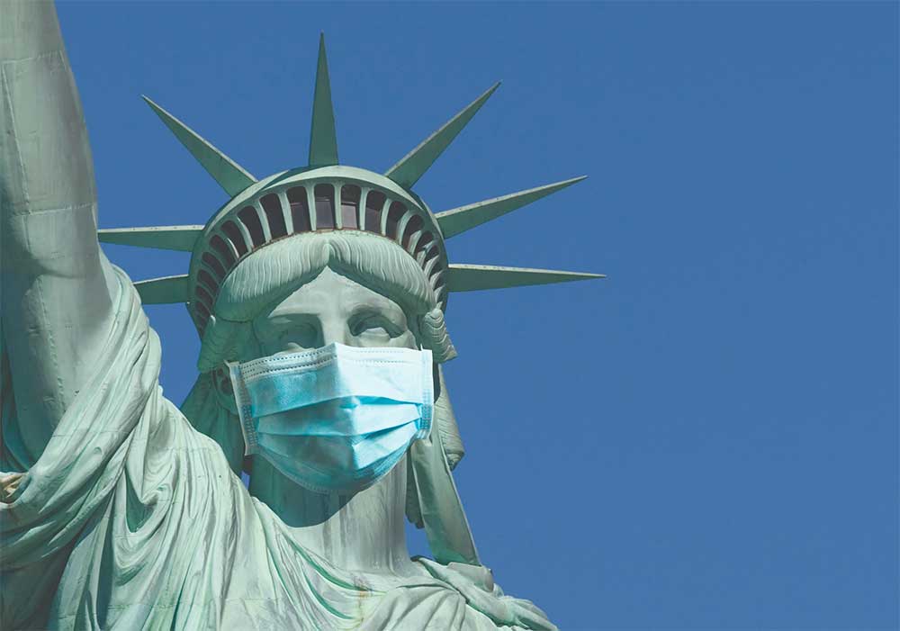 Statue of Liberty wearing a blue medical mask over the nose and mouth.