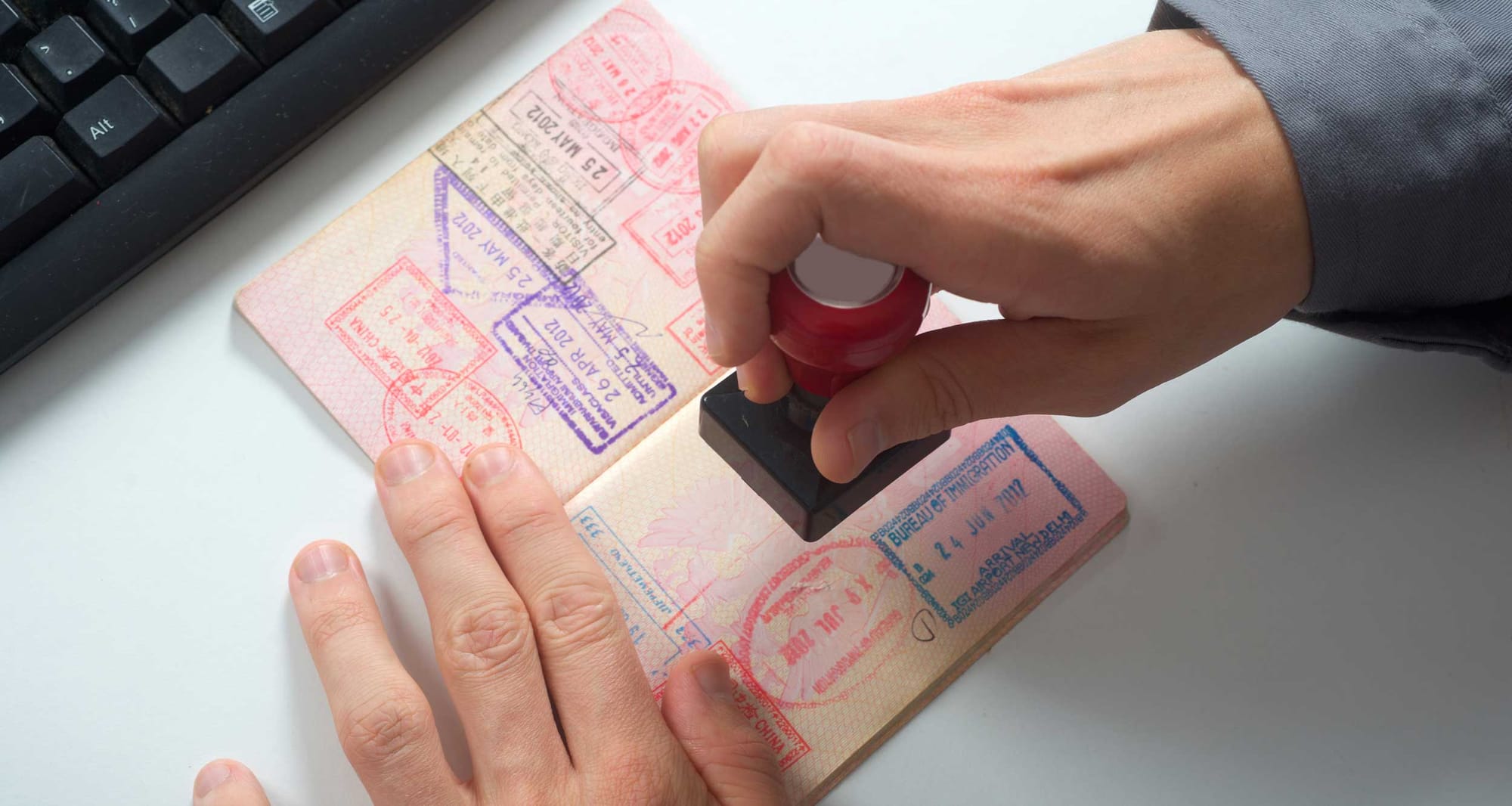 Person stamping a passport.