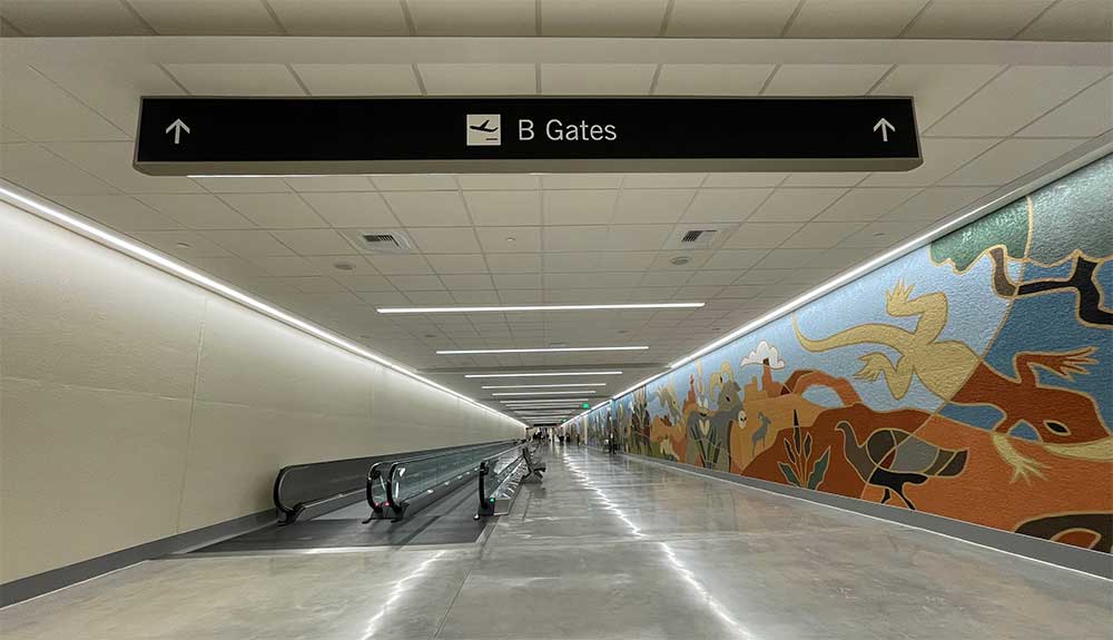 Long tunnel with moving walkway and sign pointing to B Gates.