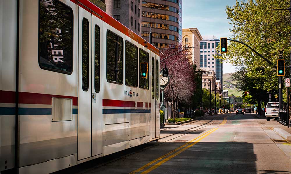 Light rail train moving along Salt Lake City street.