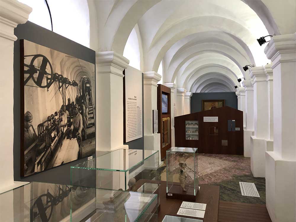 Arched hallway with art exhibits.