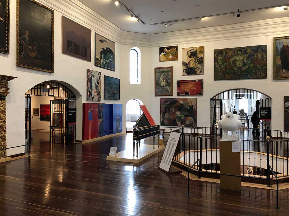 Large room with art displays.