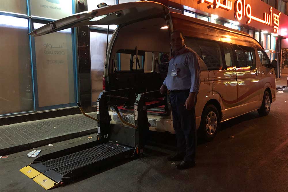 Dubai wheelchair taxi van with rear lift extended.