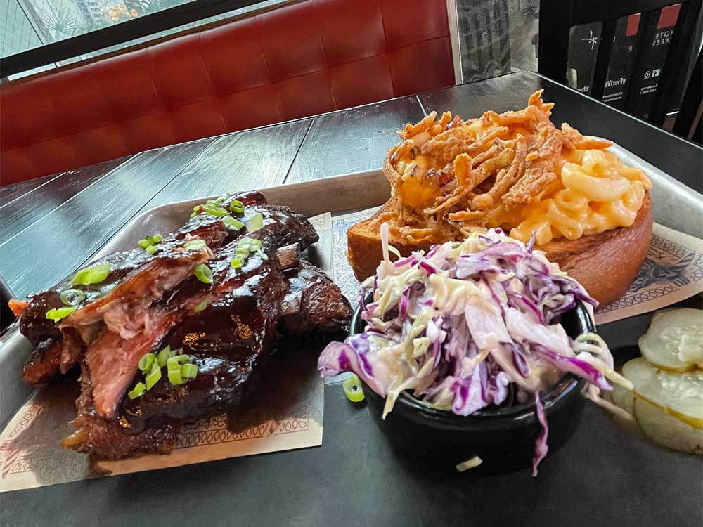 Ribs with fries, macaroni and coleslaw.