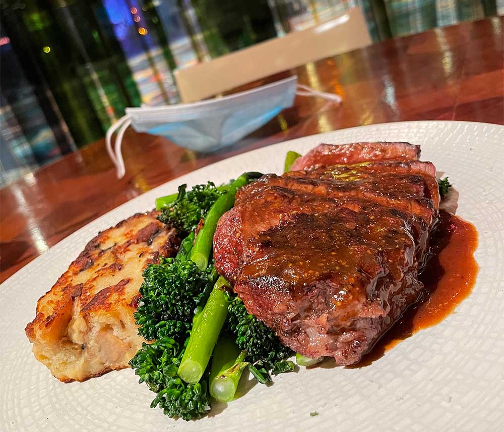 Sliced Mesquite-grilled steak with broccolini.