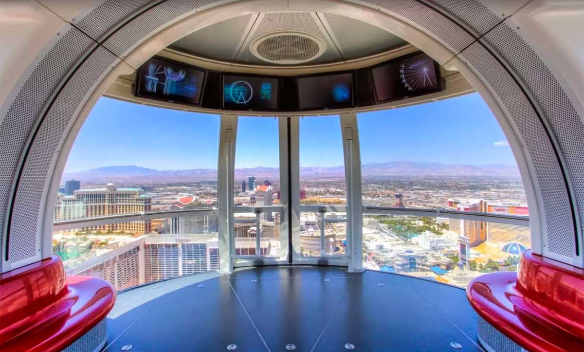 Interior of ferris wheel pod, with Las Vegas Strip seen through large windows.