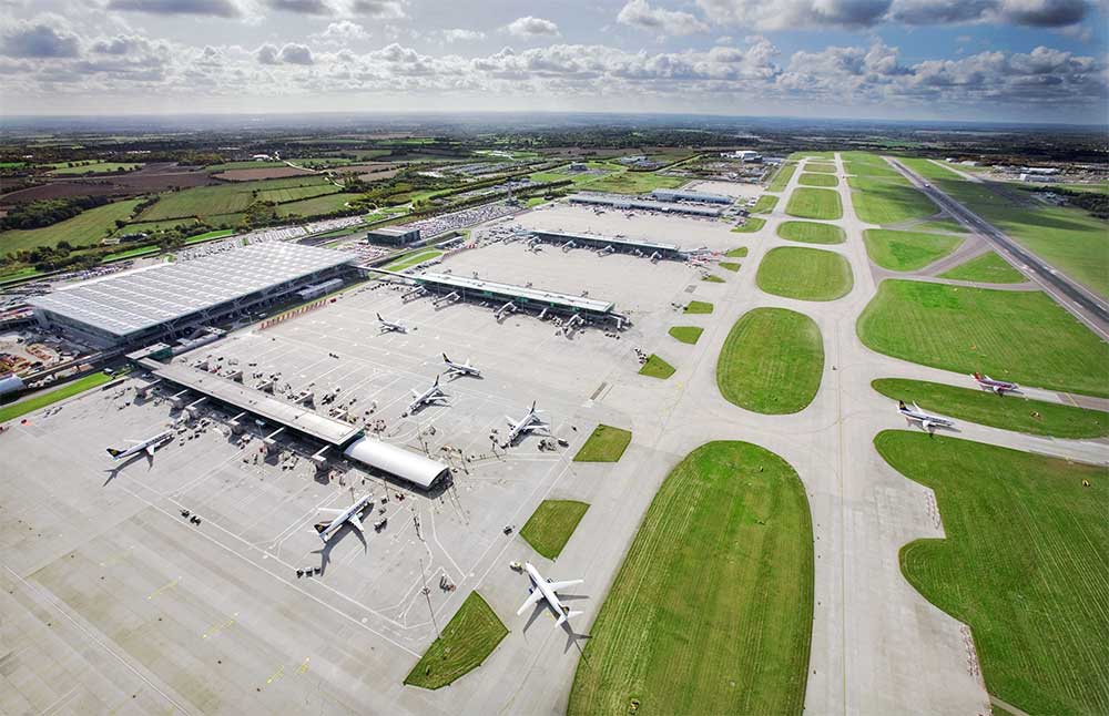 Aerial view of London airport with terminal buildings and runways.