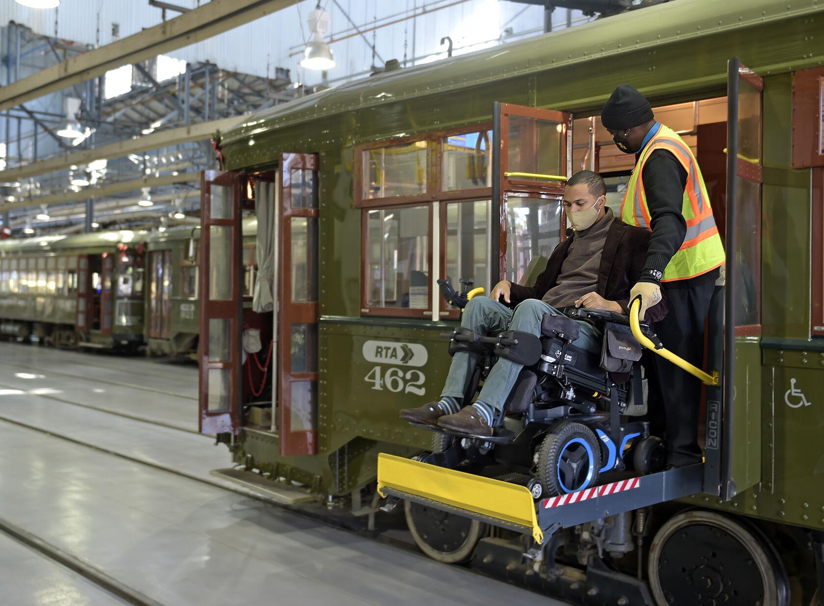 Wheelchair user on streetcar ADA lift.